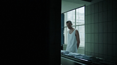 a man standing in front of a window in a kitchen