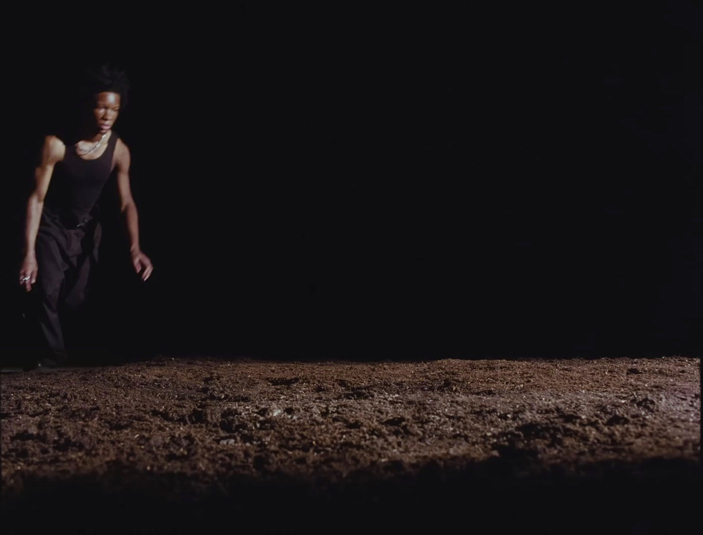 a man standing on top of a dirt field