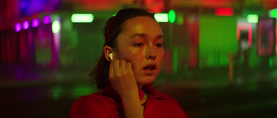 a woman in a red shirt talking on a cell phone