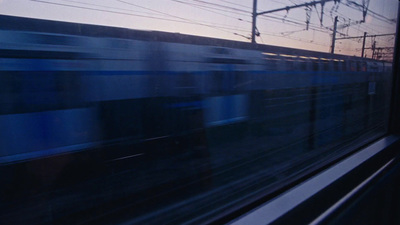 a train traveling down train tracks next to power lines