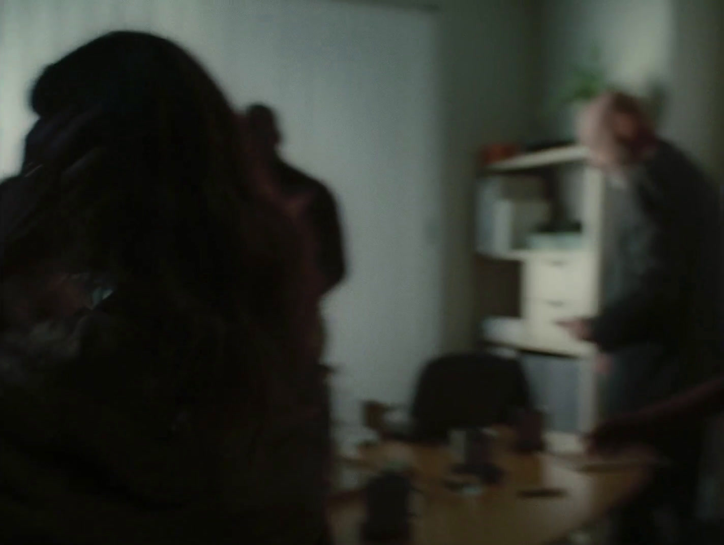 a blurry photo of a man and a woman in a living room