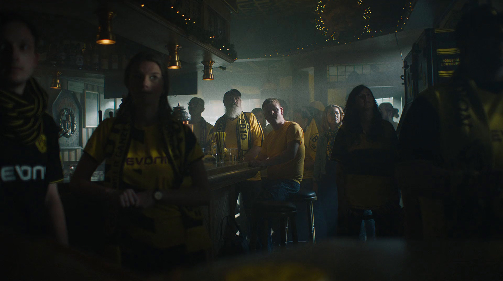 a group of people standing around a bar