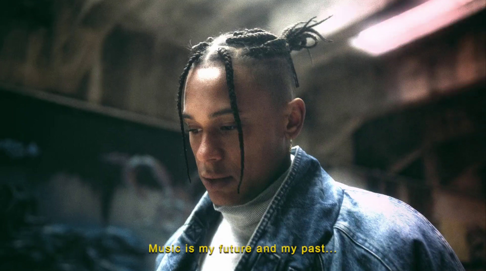 a man with dreadlocks stares at the camera