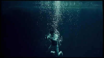 a man swimming in the ocean under water