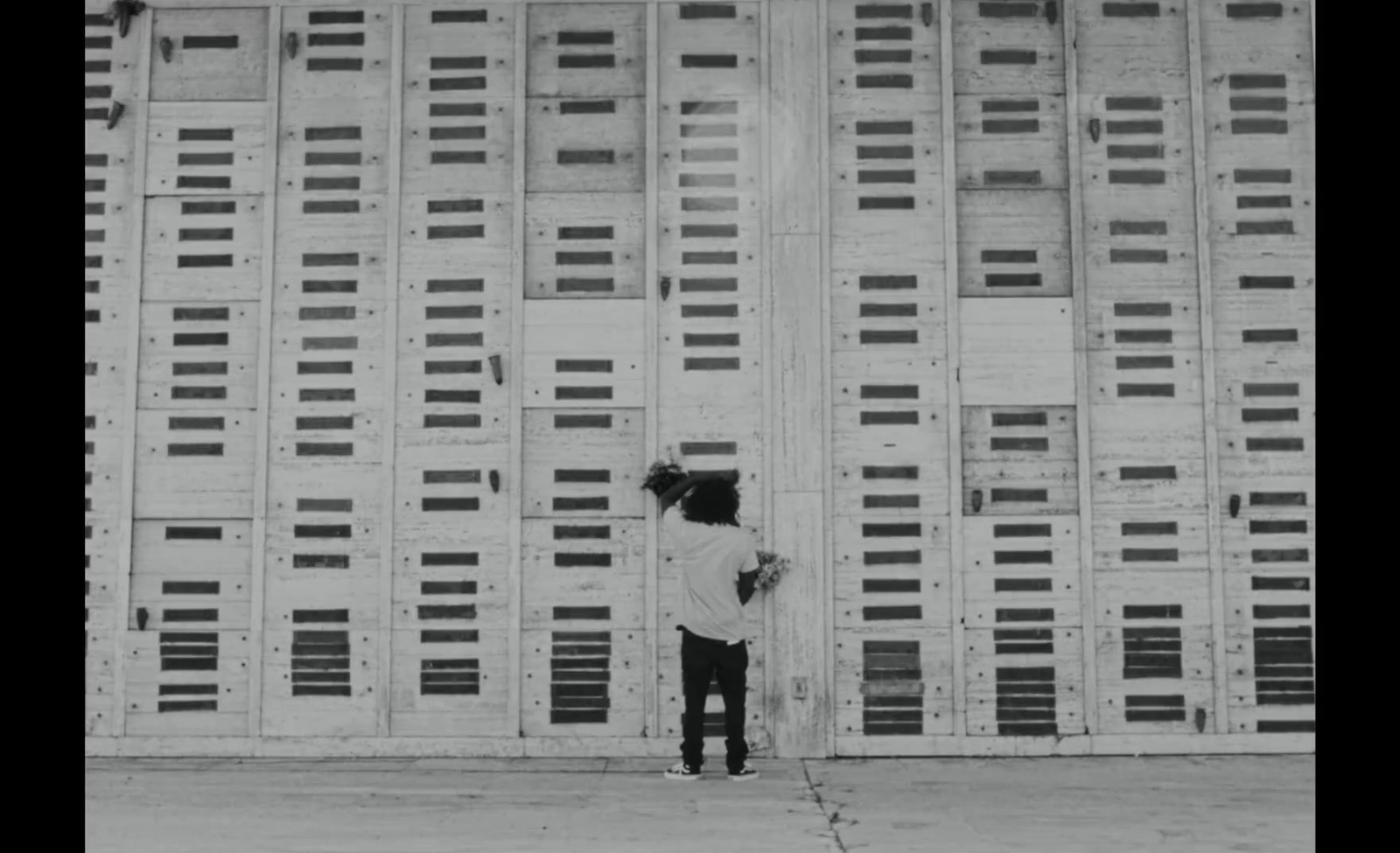 a person standing in front of a tall building