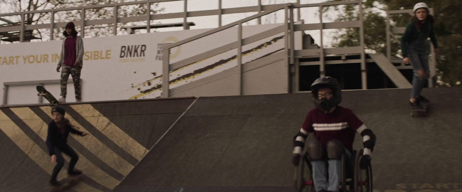 a group of people riding skateboards at a skate park