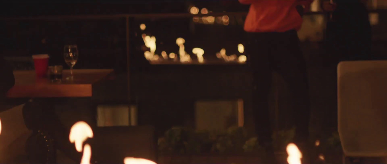 a man standing in front of a bunch of lit candles