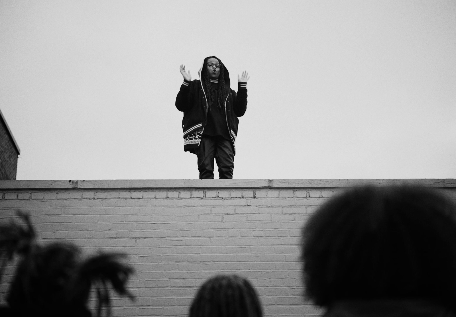 a man standing on top of a brick wall