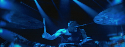 a man playing drums on stage at a concert