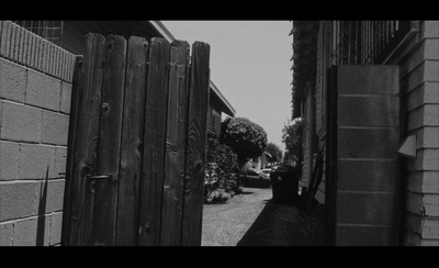 a black and white photo of an alley