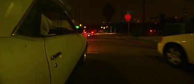 a car driving down a street at night