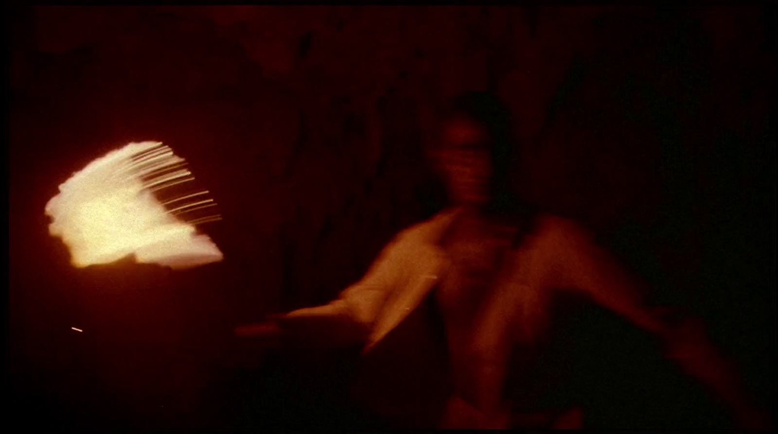 a woman standing next to a fire hydrant in the dark