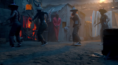 a group of people walking down a dirt road