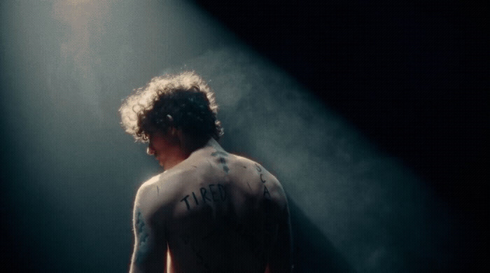 a man standing in front of a spotlight on a stage