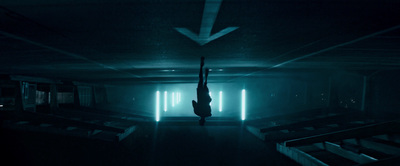 a person hanging upside down in a dark room