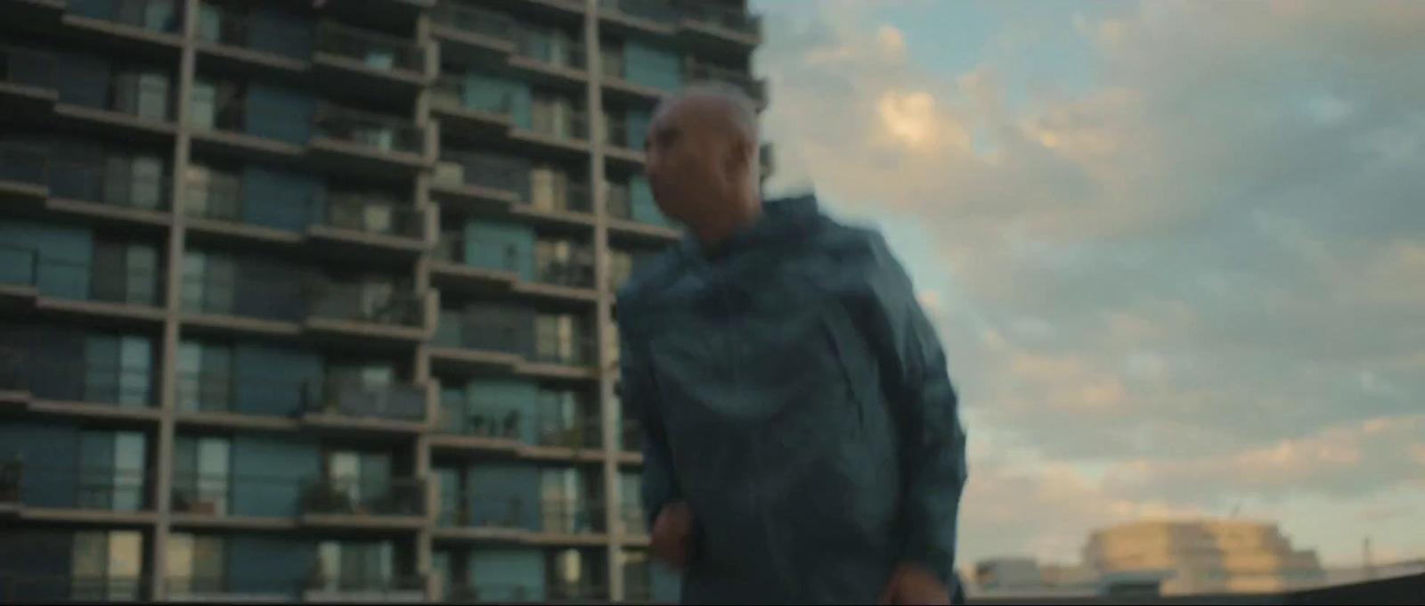 a man standing in front of a tall building