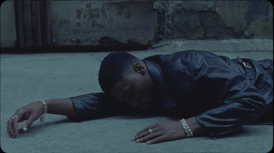 a man laying on the ground with his head down