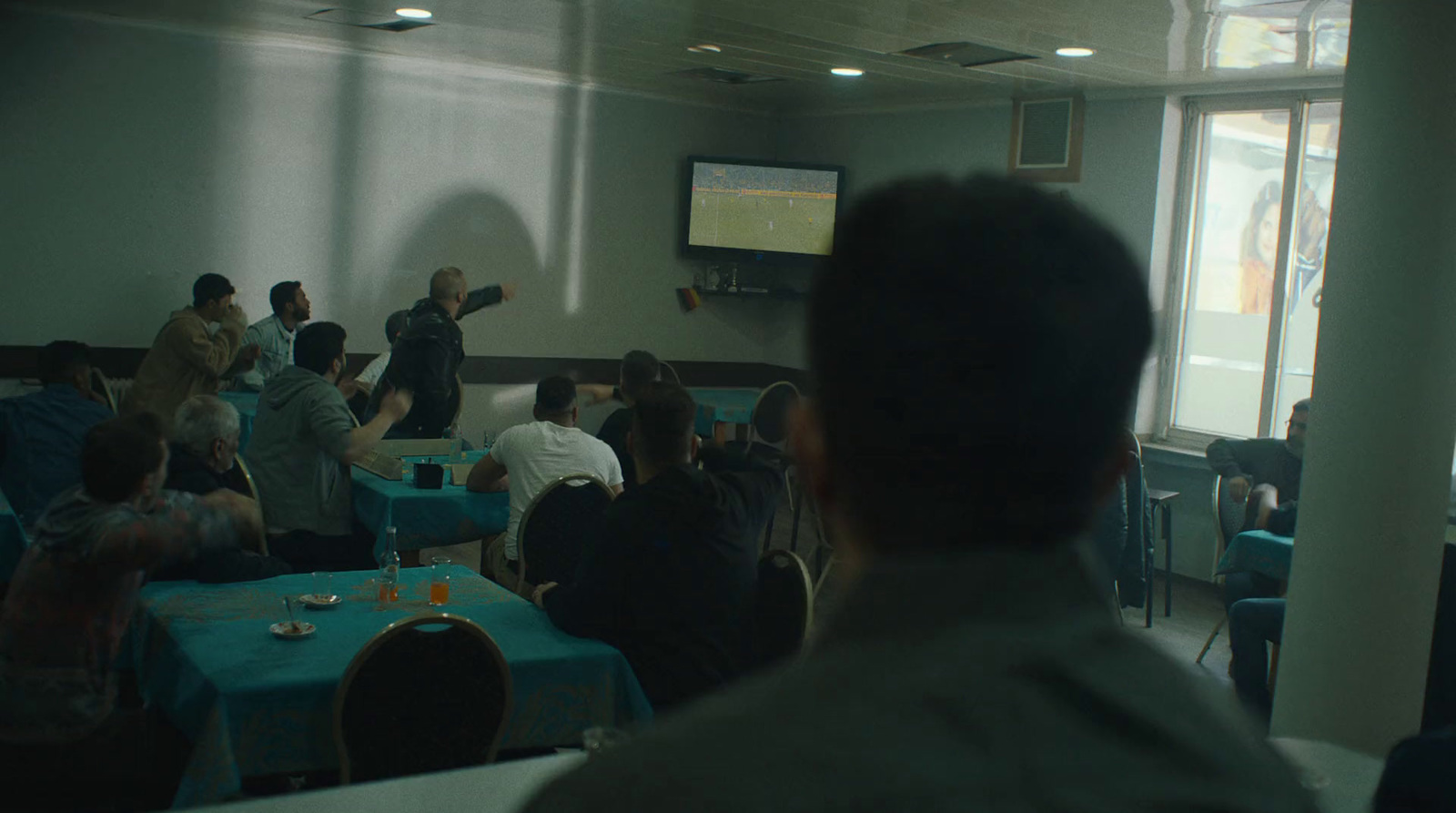 a group of people sitting around tables in a room