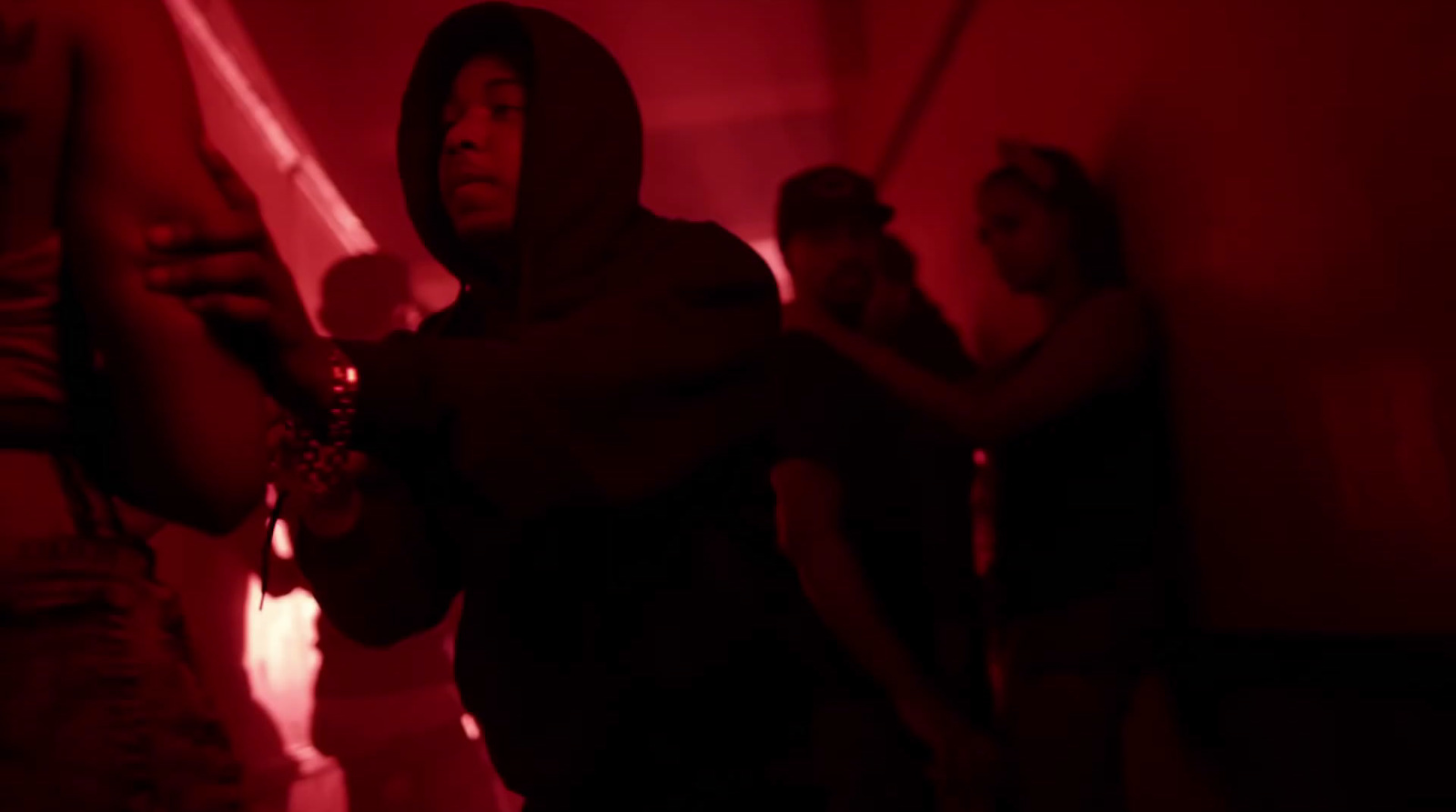 a group of people standing in a room with a red light