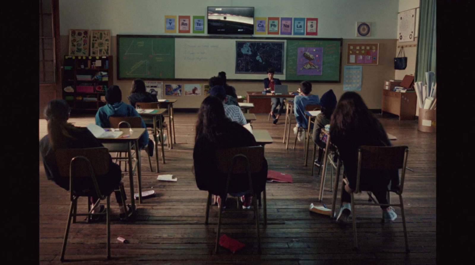 a group of students sitting at desks in a classroom