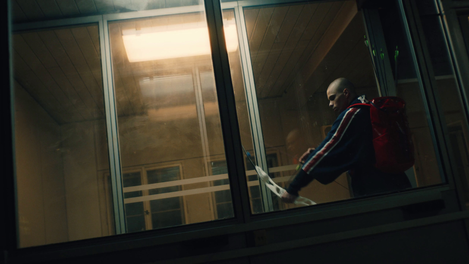 a man walking out of a building at night