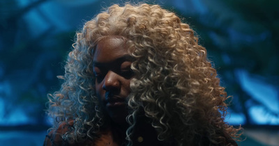 a close up of a person with curly hair