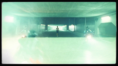 a group of people riding motorcycles through a tunnel