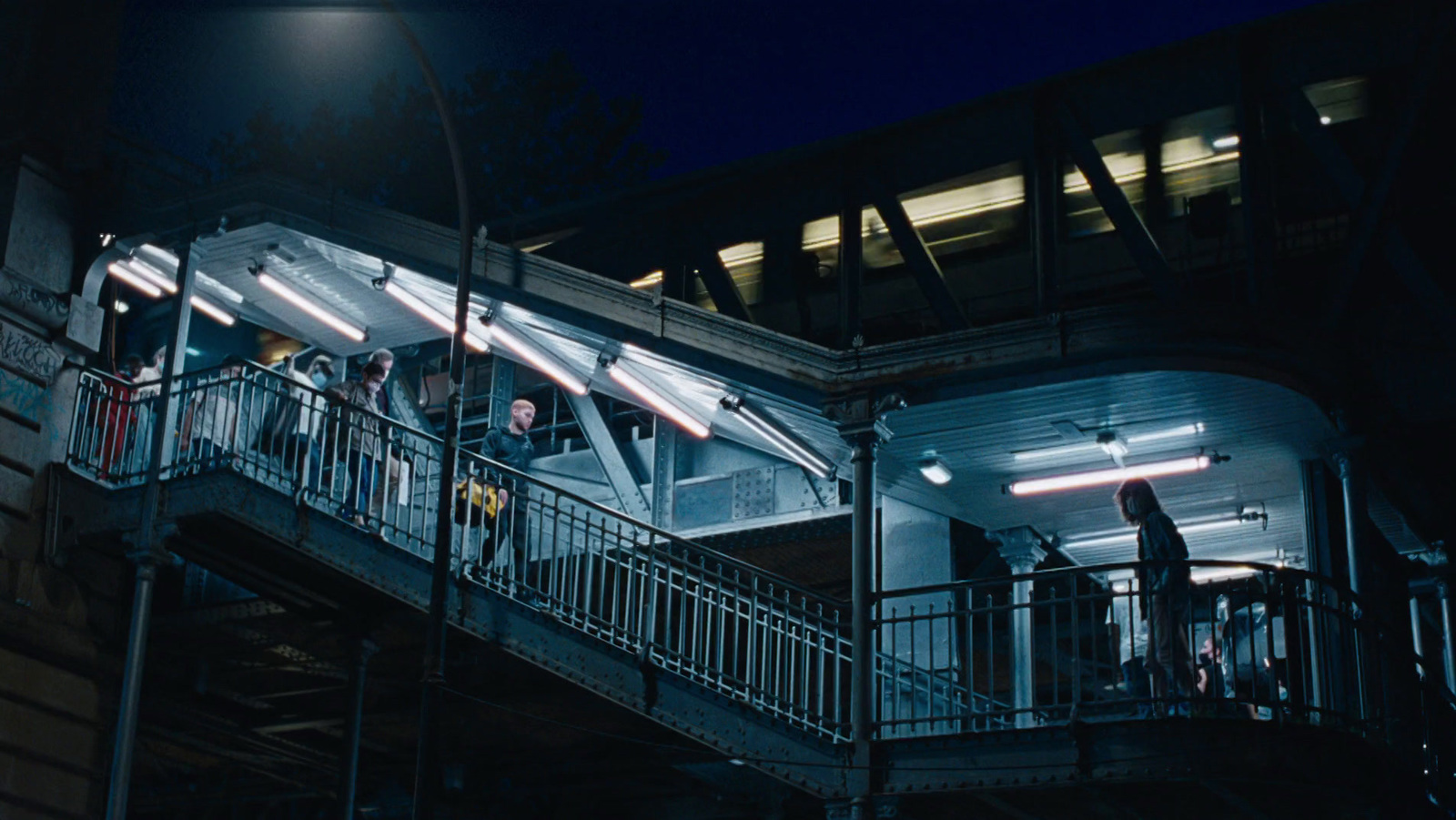 a group of people standing on a balcony at night