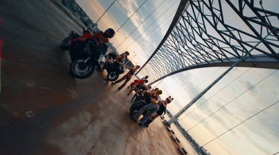 a group of people standing next to a motorcycle