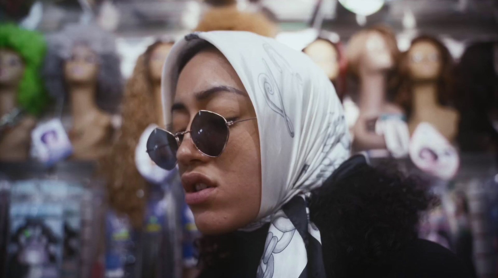 a woman wearing sunglasses and a headscarf