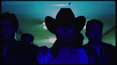 a woman wearing a cowboy hat standing in a room