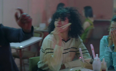 a woman sitting at a table with a plate of food