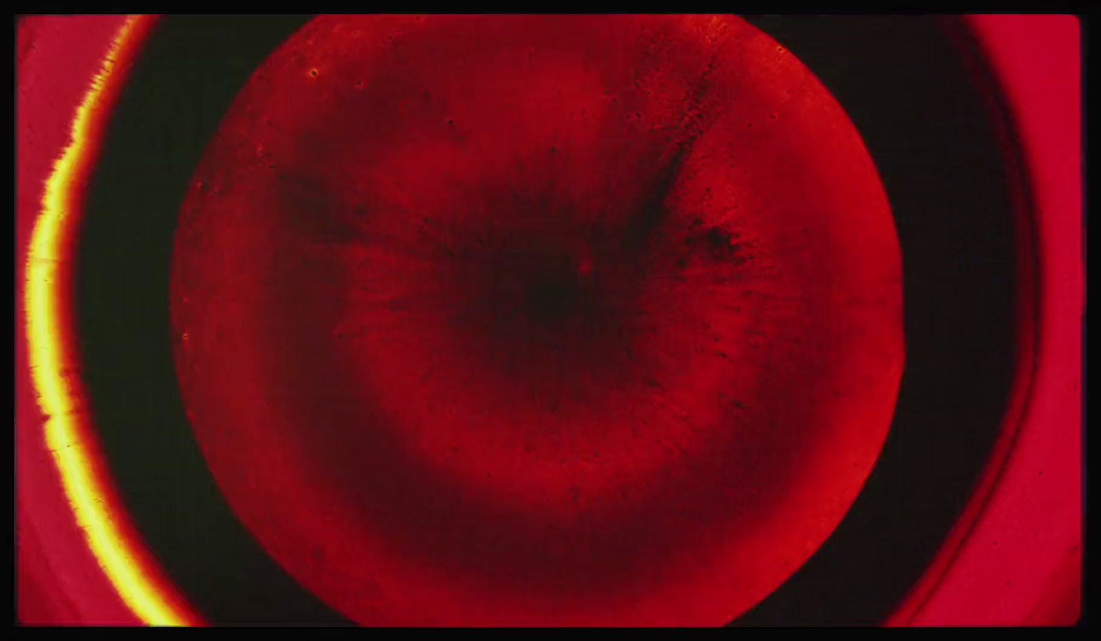 a close up of a red object with a black background