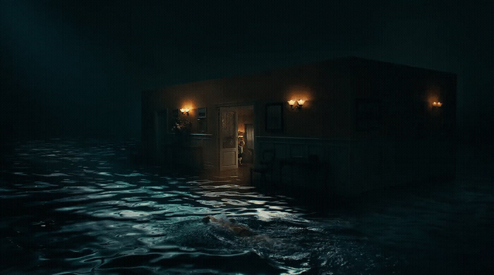 a house in the middle of a body of water at night