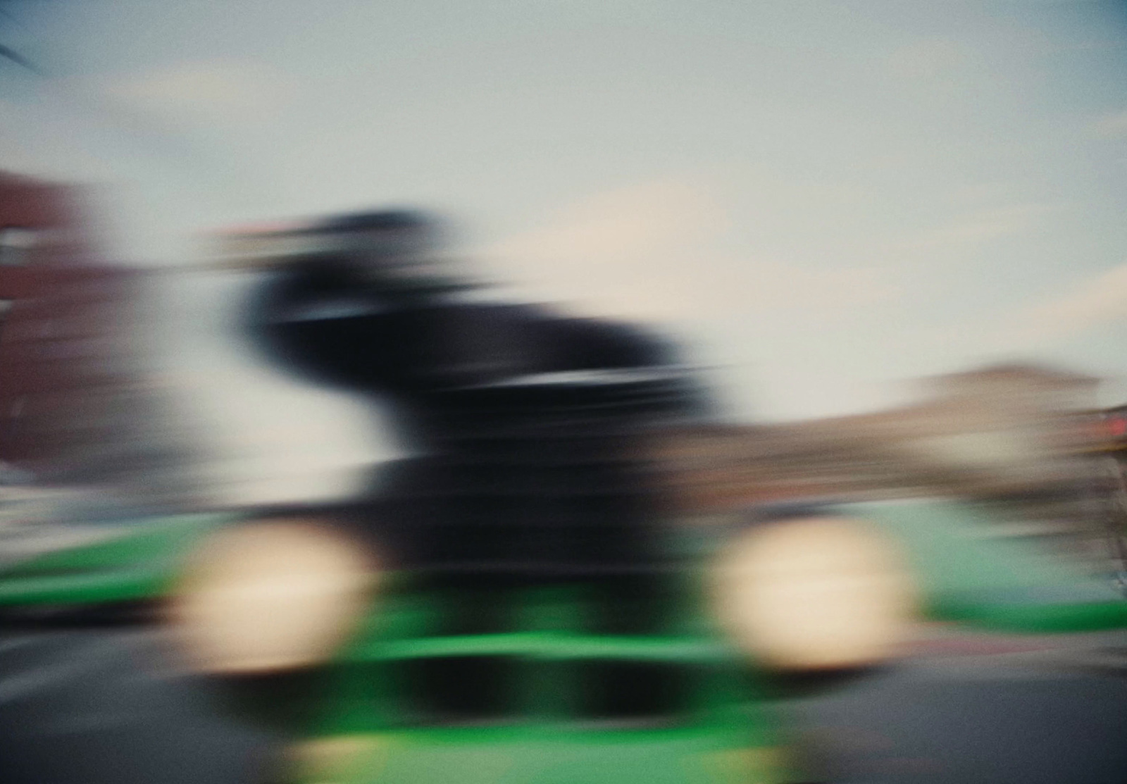 a blurry photo of a person riding a toy train