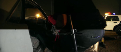 a police car parked in a parking lot at night