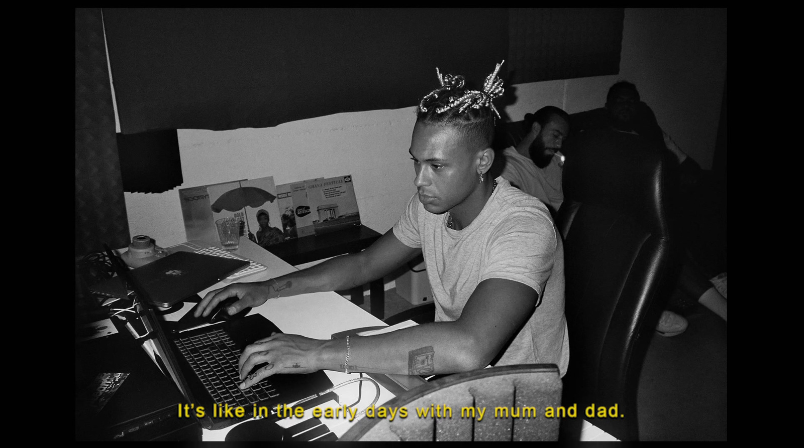 a man sitting at a desk with a laptop computer