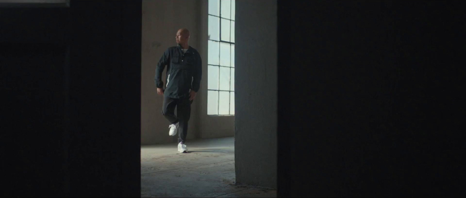 a man is walking through a dark room