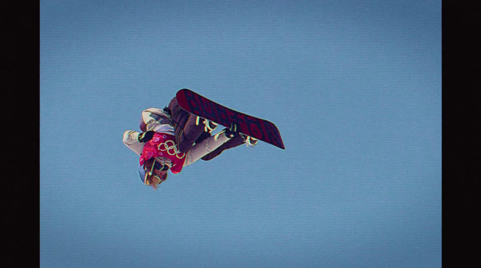 a man flying through the air while riding a snowboard