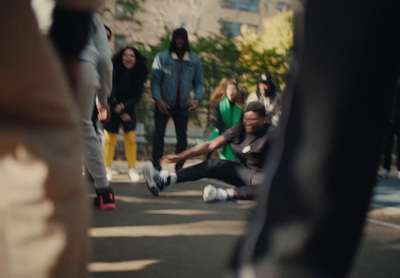 a group of people standing and sitting on the side of a road