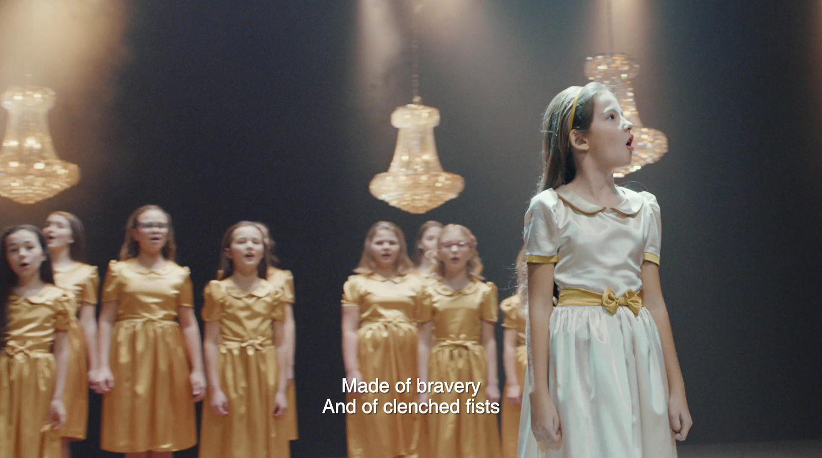 a group of young girls standing next to each other