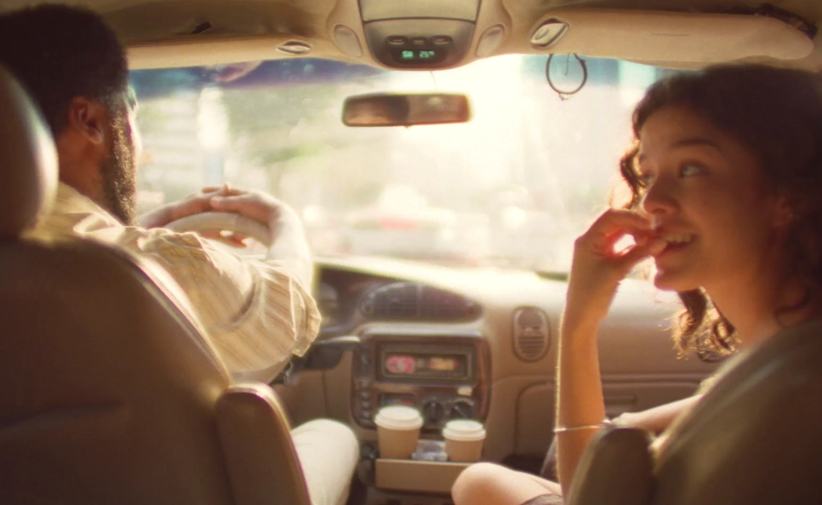 a woman talking on a cell phone while driving a car