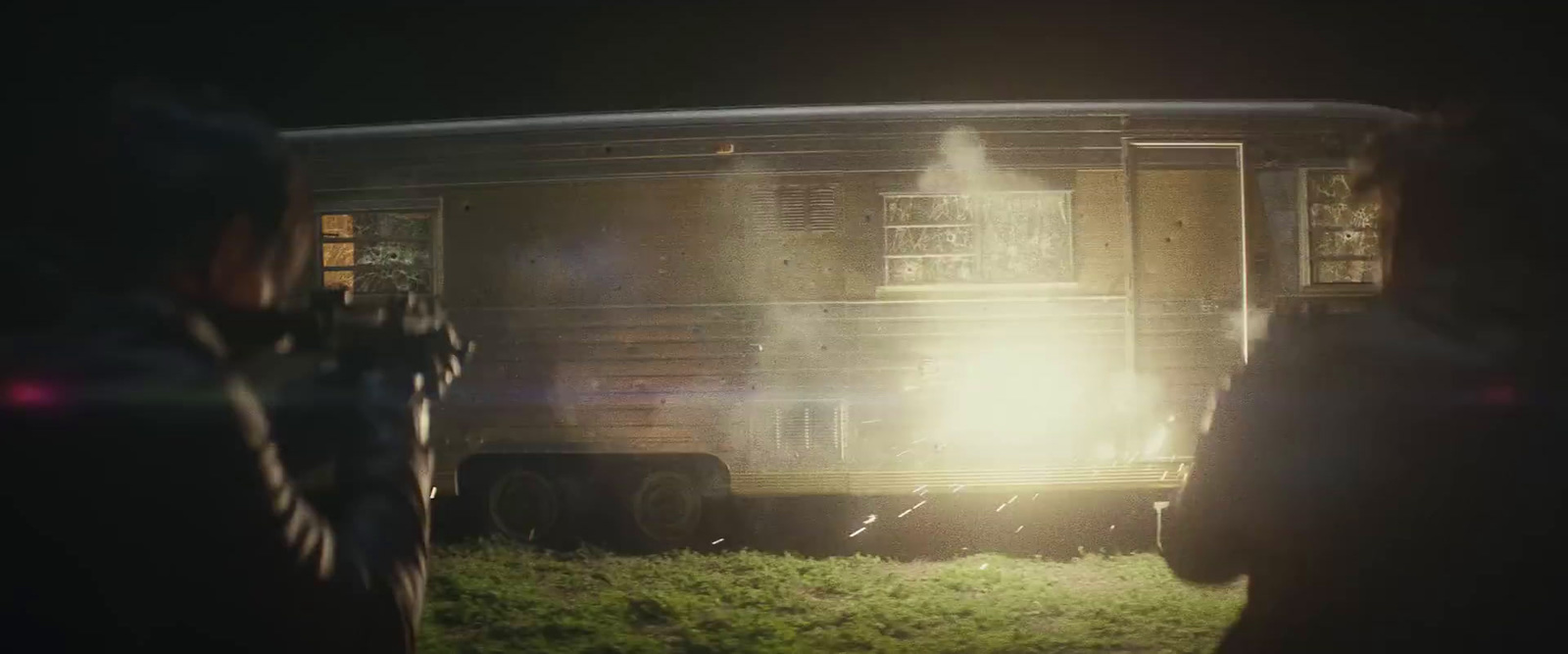 a person standing in front of a train car at night