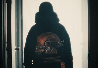 a person wearing a hoodie with a clock on it