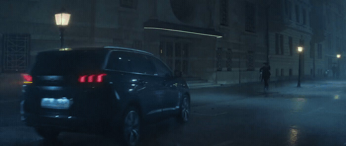 a car driving down a street at night