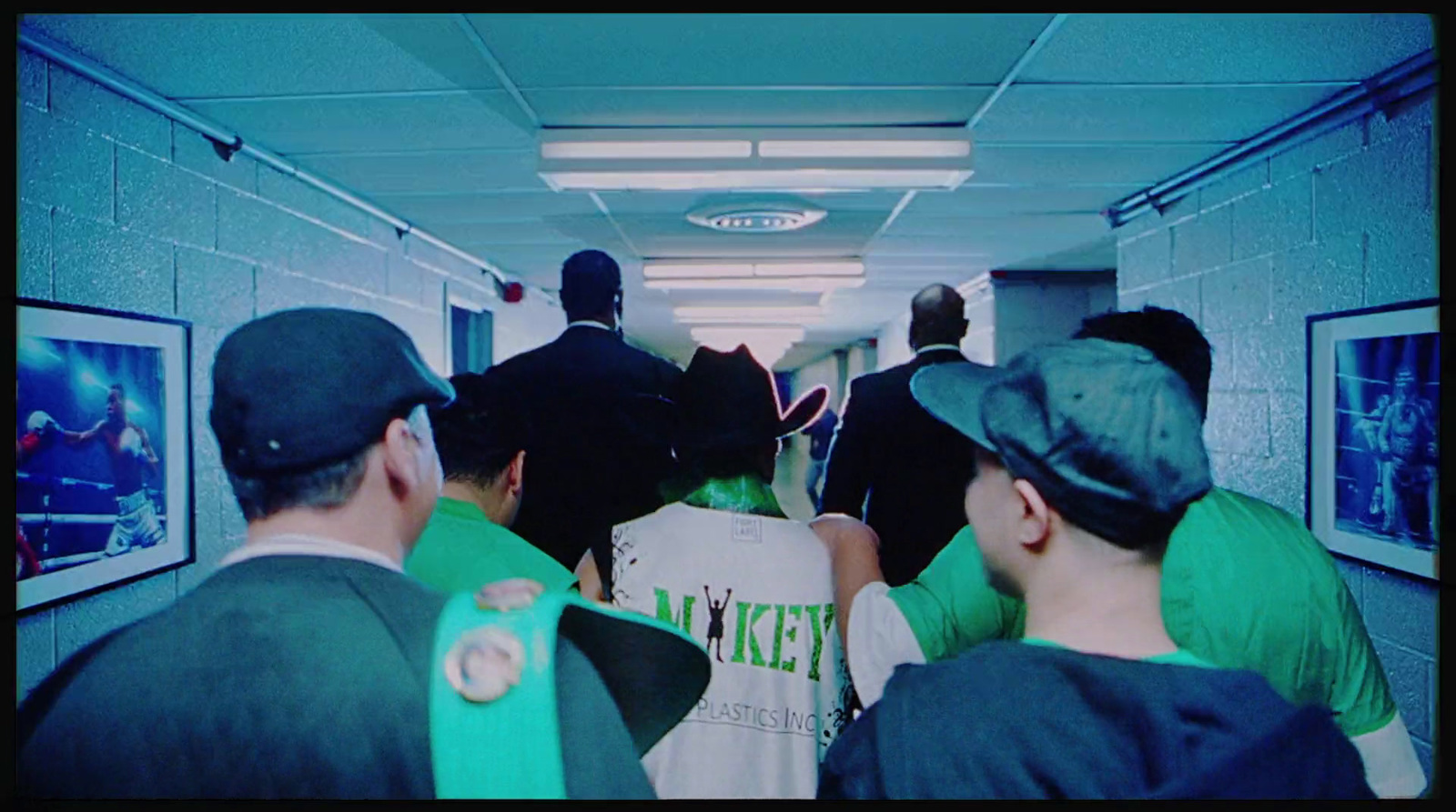 a group of men walking down a hallway