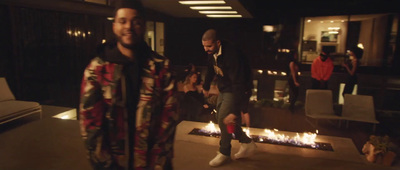 a group of men standing around a fire pit