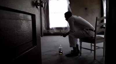 a man sitting on a chair in a room