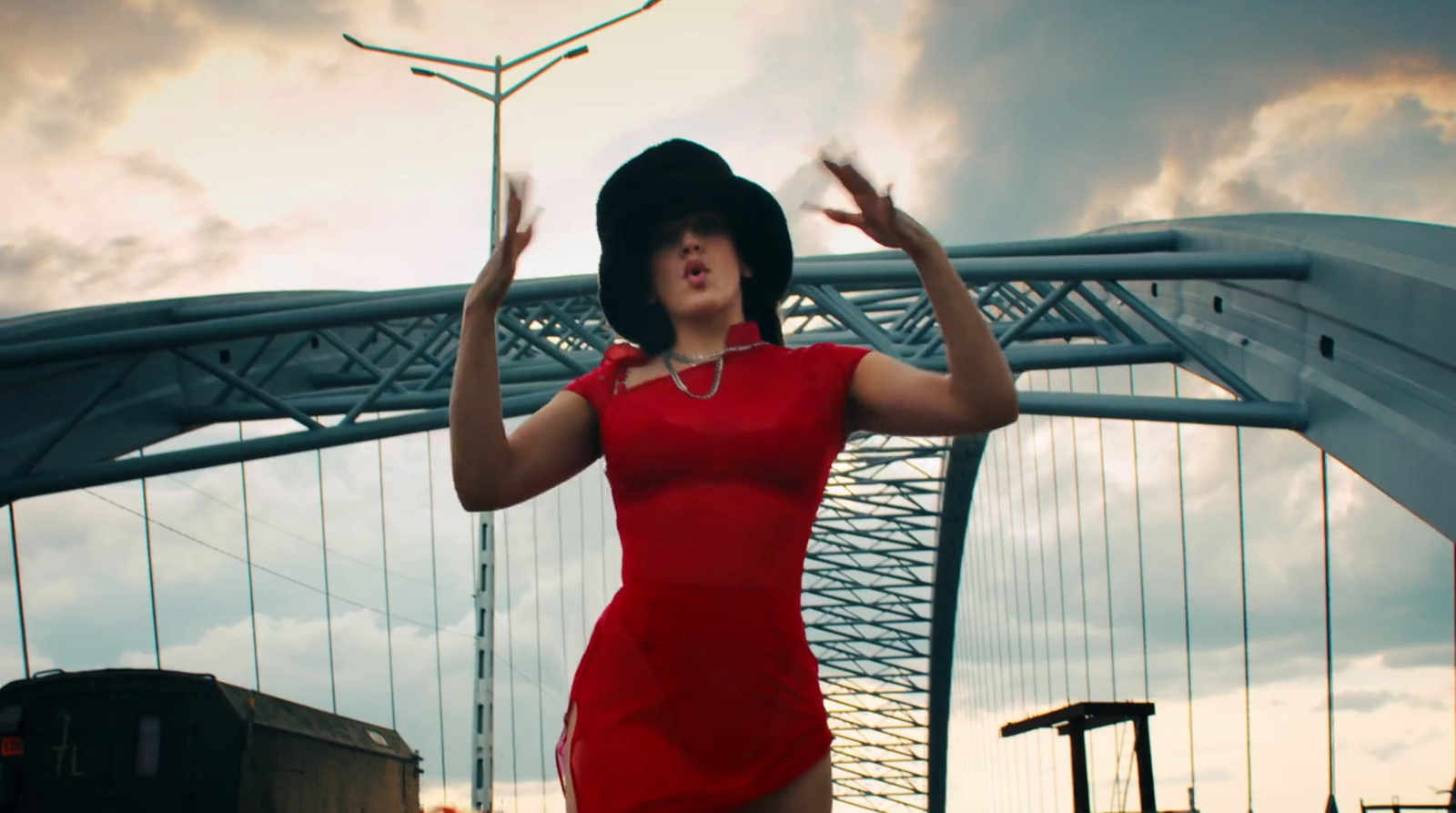 a woman in a red dress and black hat