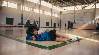 a woman laying on the floor in a gym